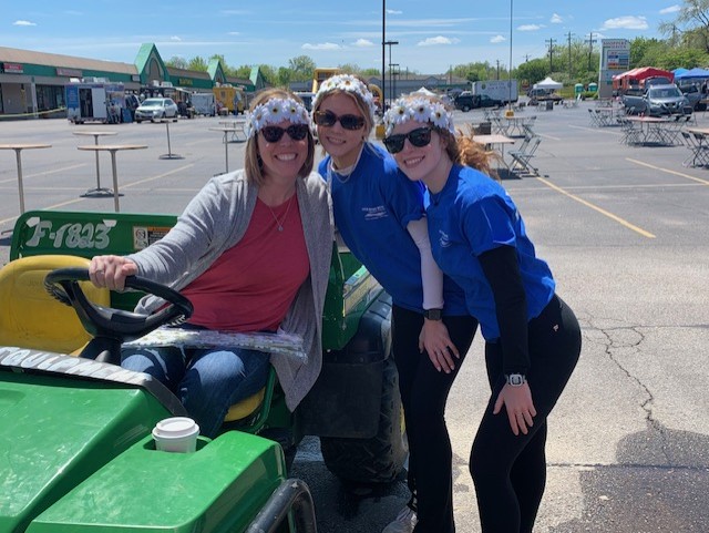 women in parking lot for event